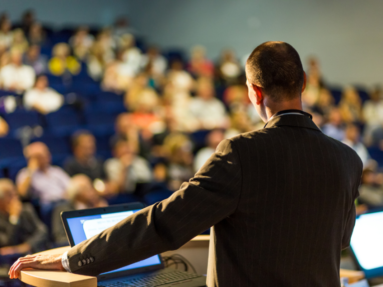 Keynote speaking presenting to an audience